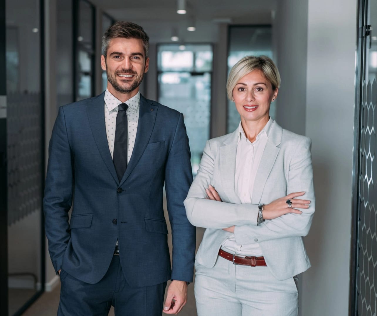 Professional business team standing confidently in modern office